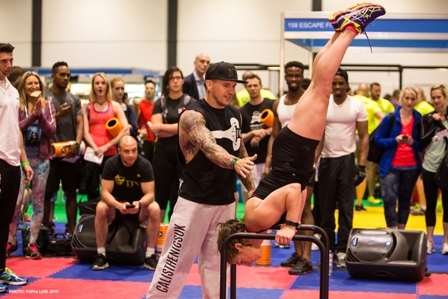 One delegate takes on the  handstand whilst spectators look on aghast 