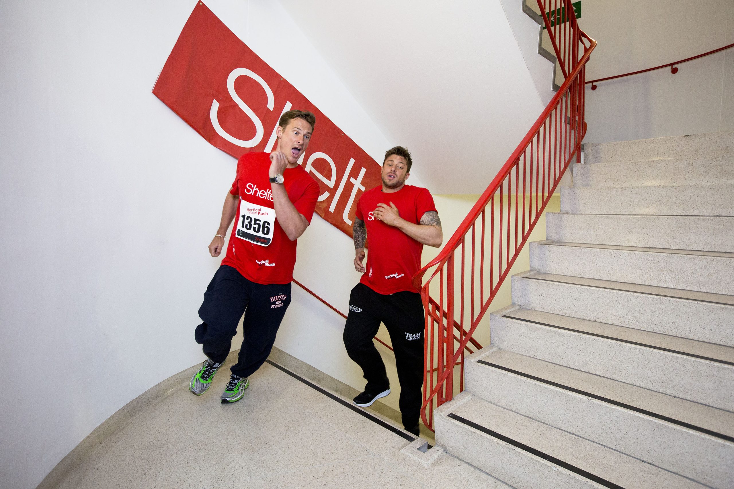 Lee Ryan (L) and Duncan James, members of boy-band 'Blue', run up steps to the top of Tower 42  Photo credit: Shelter/Matt Cetti-Roberts