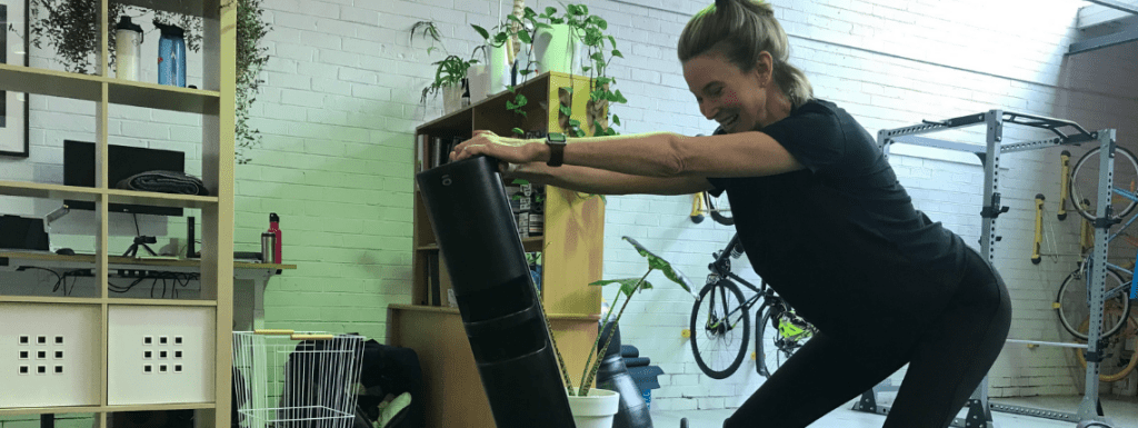 A woman strength training at a home gym