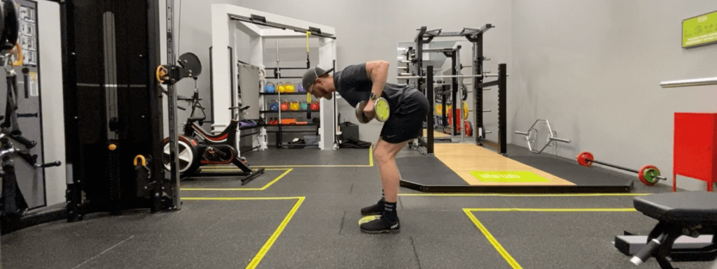 A man doing a superset exercise in the gym