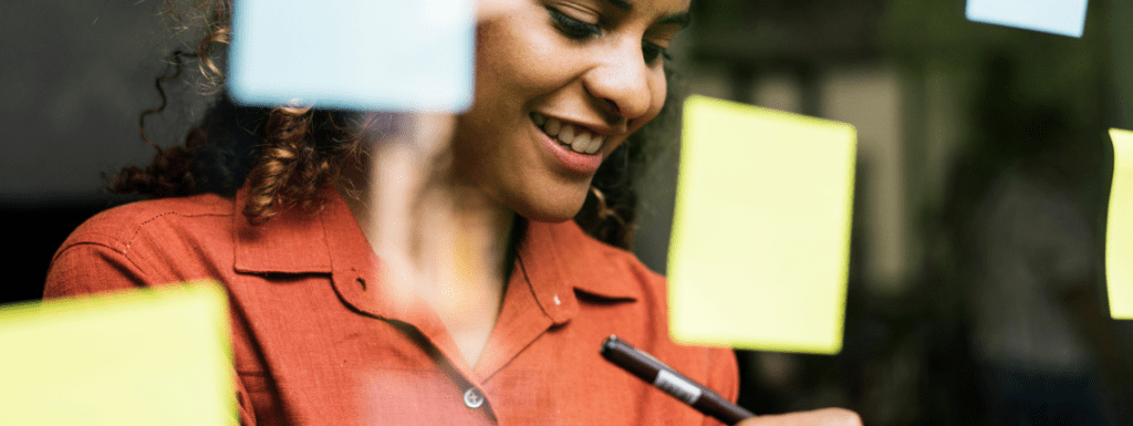 woman writing on post it notes