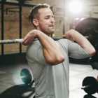 Man focused on lifting weights during a strength training session at the gym