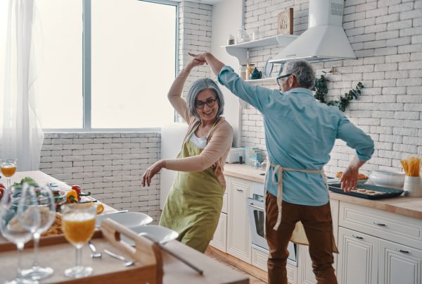 Man and woman dancing happily in their kitchen