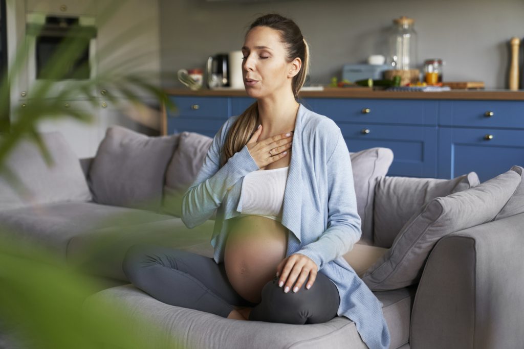 Pregnant woman relaxing on sofa