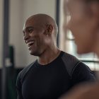 Mature fitness man laughing in gym