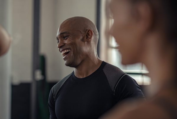Mature fitness man laughing in gym