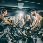 Group of people indoor cycling in a studiio