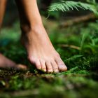 Bare feet of woman standing barefoot outdoors in nature