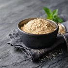 Adaptogens - image of Maca powder in a bowl with a spoon at the side
