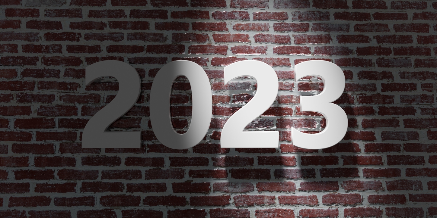 Get ready for 2023 - Image of white digits saying 2023 on red brown brick wall background.