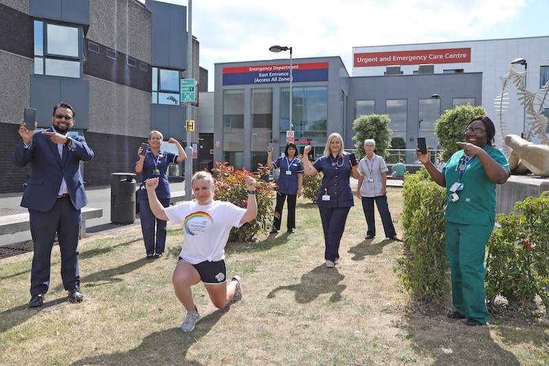 DoingOurBit - Image of staff outside a hospital holding up their devices to promote #DoingOurBit