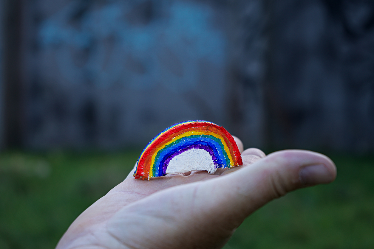 Professionalism #DoingOurBit - image of hand painted arts placed on a hand - it features a rainbow