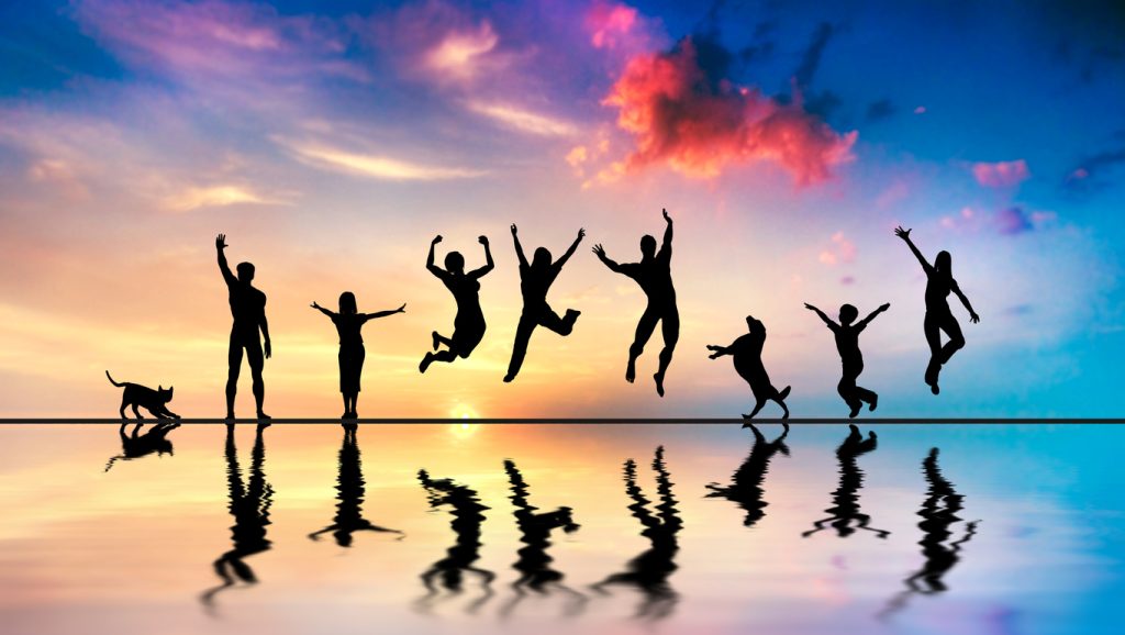 New year hacks - image of happy group of friends, family with dog and cat jumping together at sunset with a water reflection