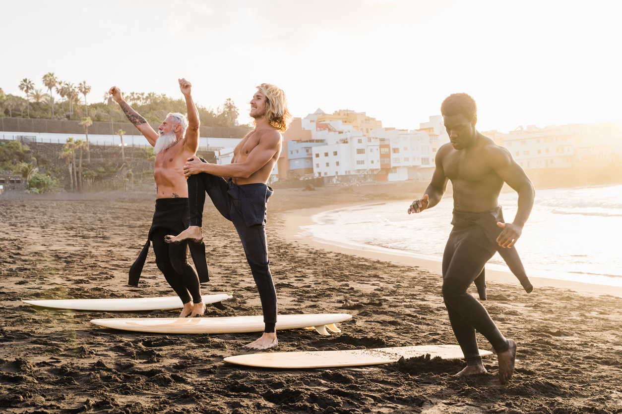 Functional Balance - Image of men warming up at the beach with their surfboards