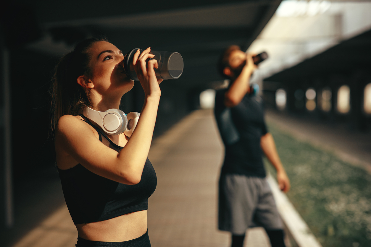 Protein Powders - Image of young woman and man drinking protein shake after workout