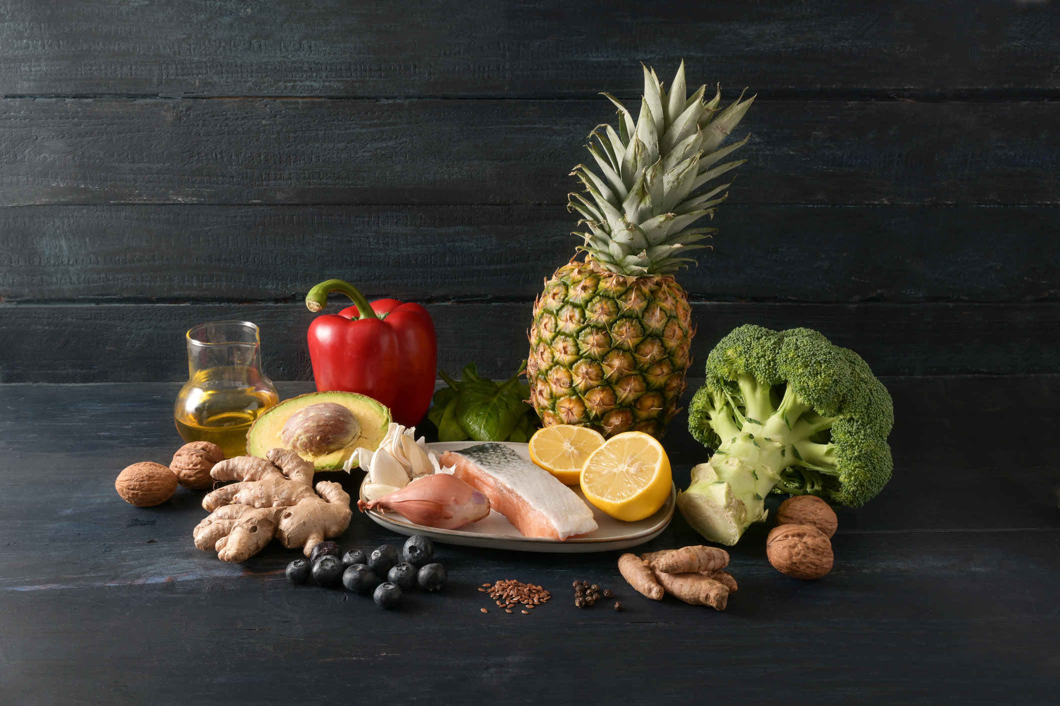 Anti-inflammatory diet -Image of vegetables, fish, fruits, nuts and spices for an anti-inflammatory and antioxidant diet, dark rustic wooden background