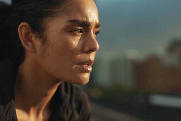 When to stop training... Woman looking exhausted and reflective whilst looking in to the distance