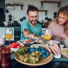 men vs women nutrition - you couple eating breakfast together while sitting at table at home