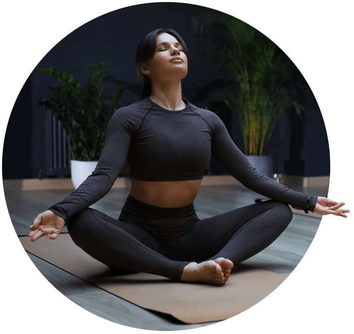 Woman sat on an exercise mat performing a yoga pose