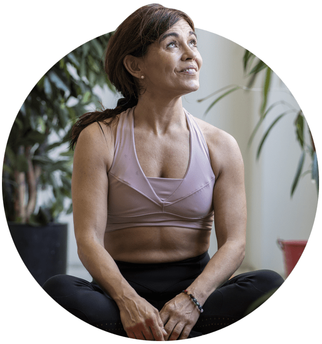 Woman sat on a mat in exercise gear