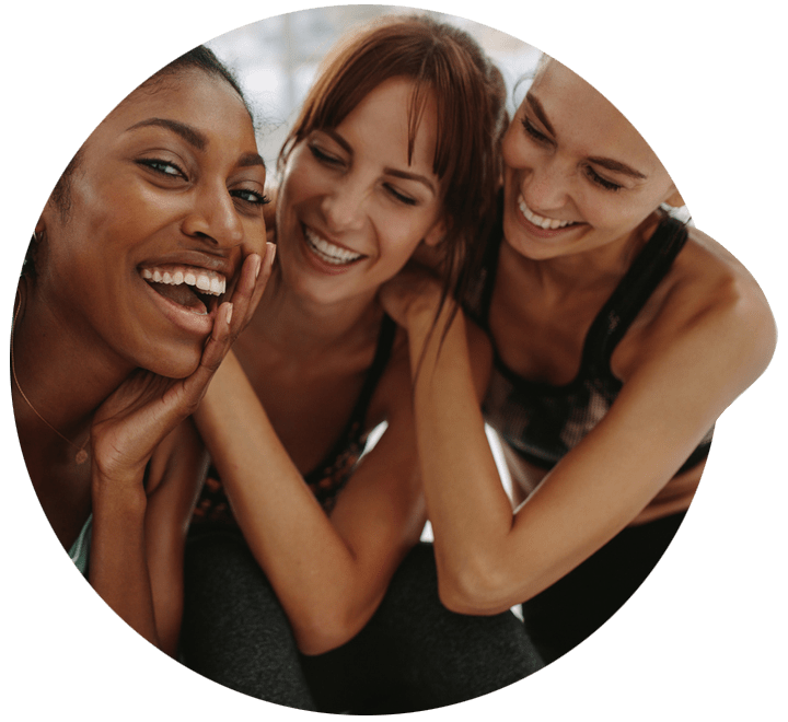 Group of women smiling / laughing while enjoying an exercise class