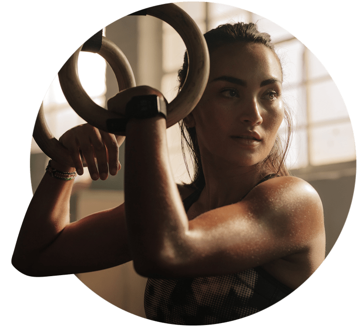 Woman exercising using gymnastic rings