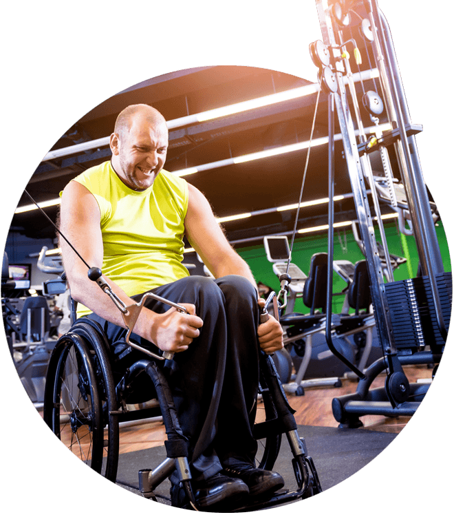Man in a wheel chair exercising using the cable machine