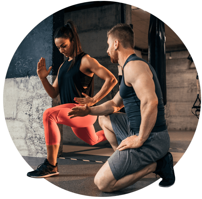 Male personal trainer taking a woman through an intense leg work out