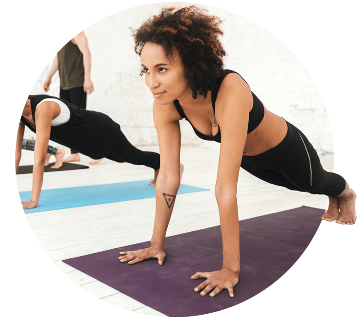 Women doing pilates exercises on an exercise mat