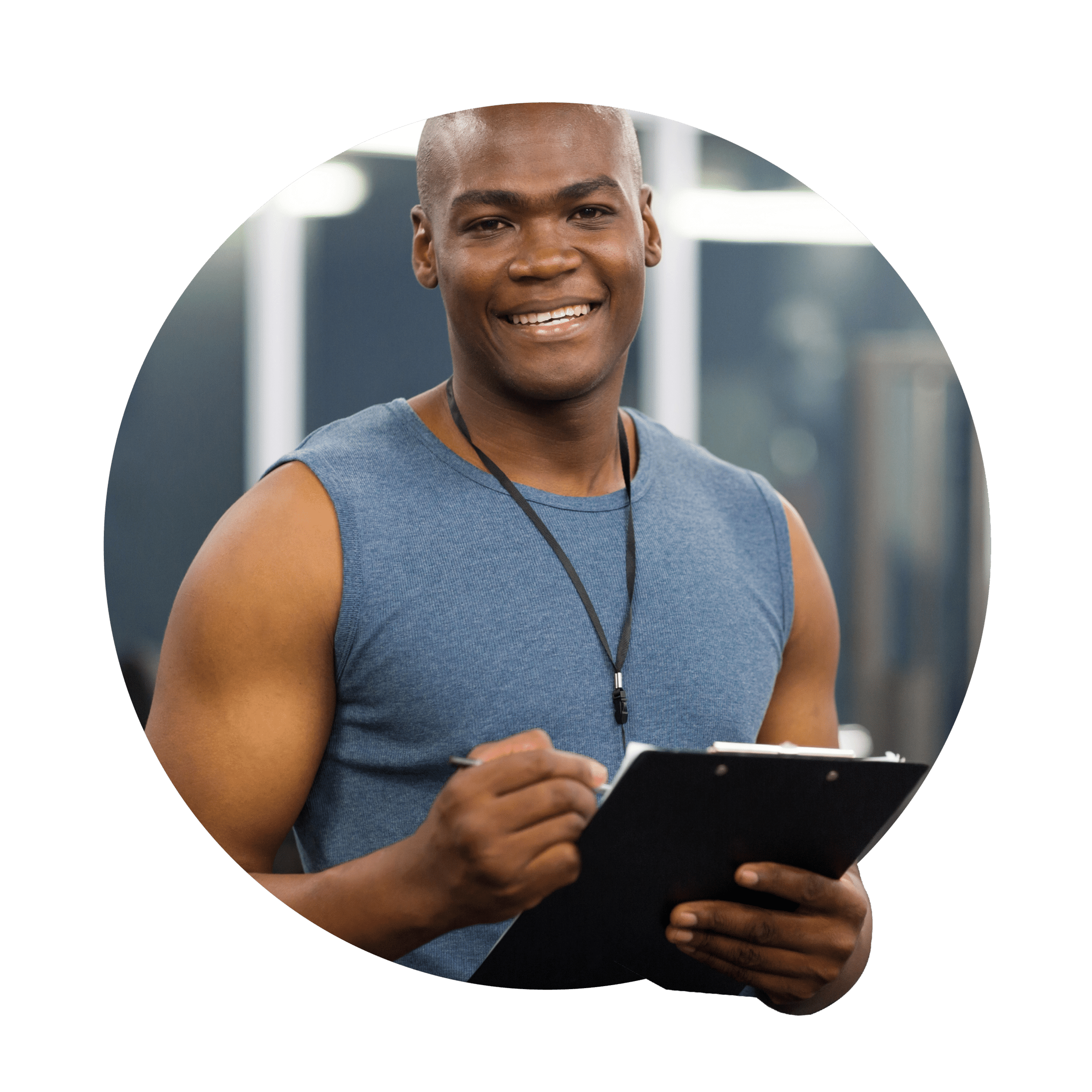 A man with a cheerful expression holds a clipboard in a gym, ready to record information.