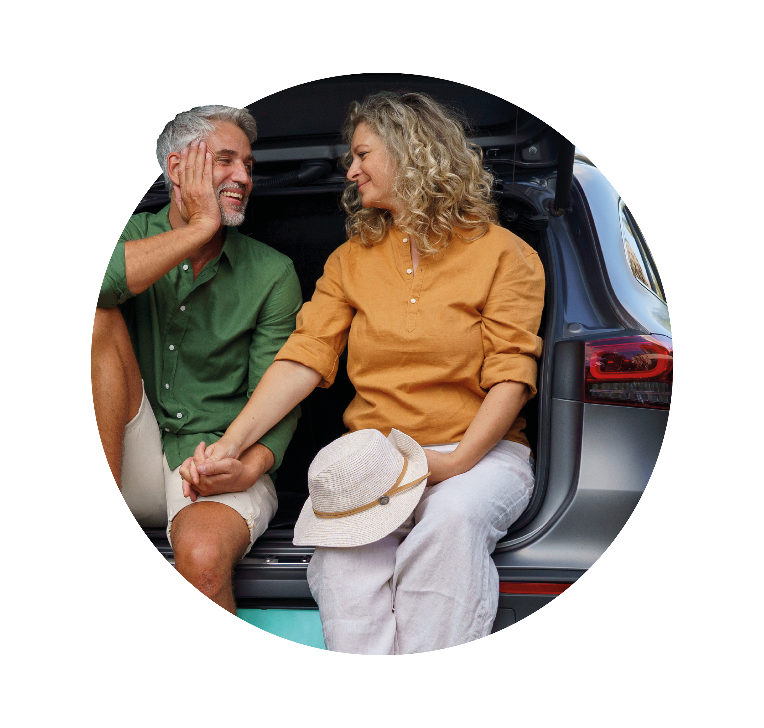 older couple perched on car boot holding hands